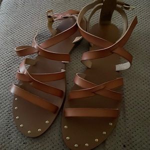 Justfab sandal that is tan with rhinestone around the top and a size 10